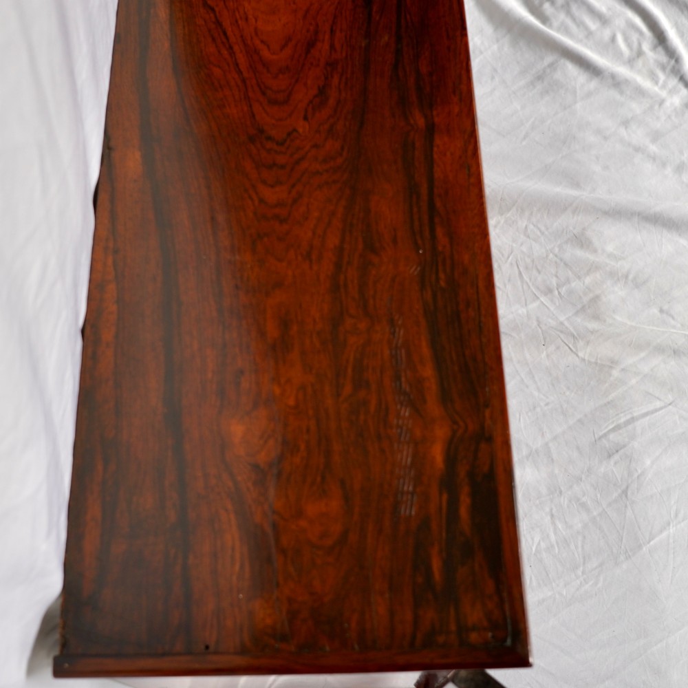 A Regency period dark rosewood tabletop collectors cabinet featuring twin banks of small drawers flanking a central mirrored shelf unit with Gothic arched carving. View XIV