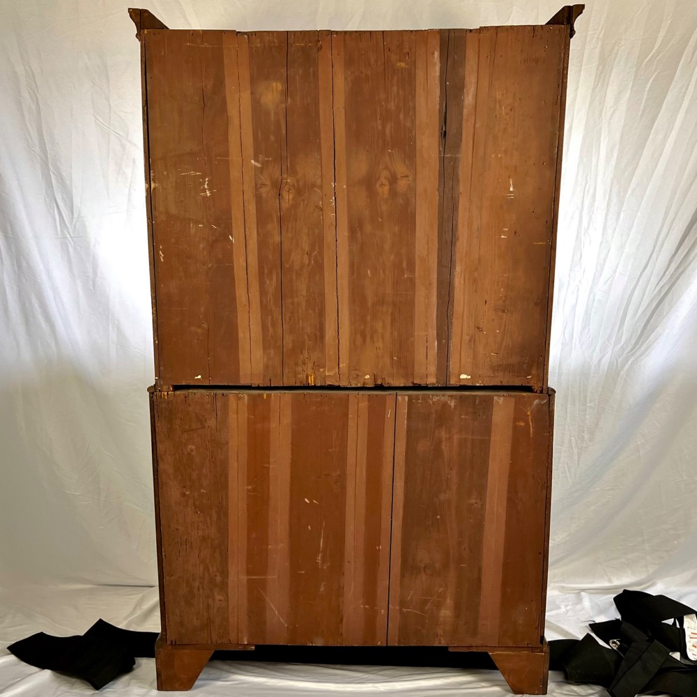 A tall George II two-part walnut chest on chest featuring figured burr walnut drawer fronts with line inlay, brass swan-neck handles, and bracket feet. View XI
