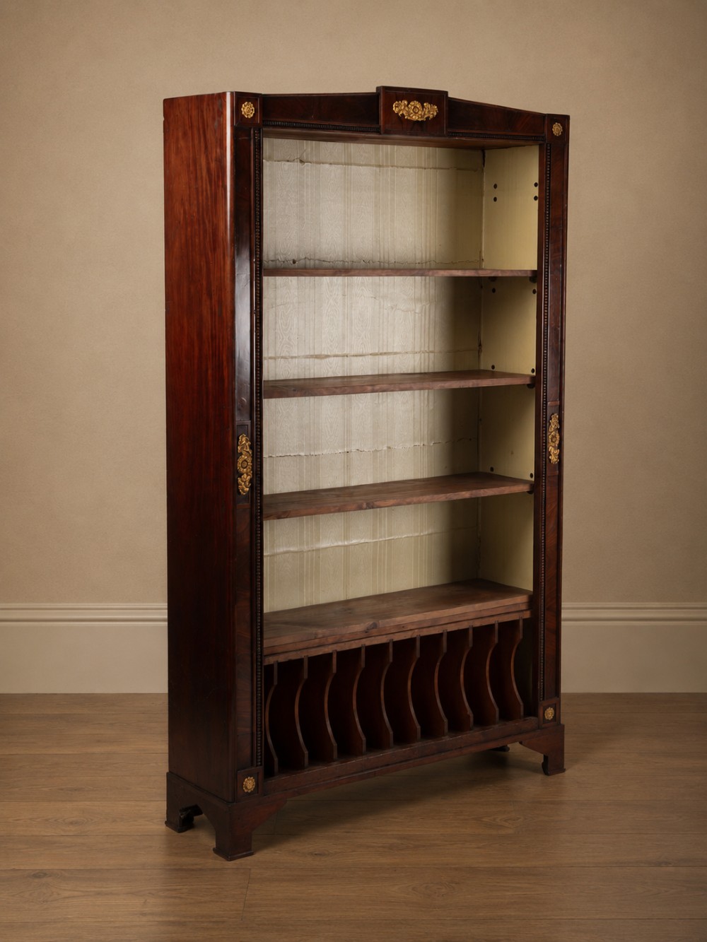 A nineteenth-century French Empire style rosewood open bookcase featuring brass mounts and adjustable shelves above vertical dividers. View XI