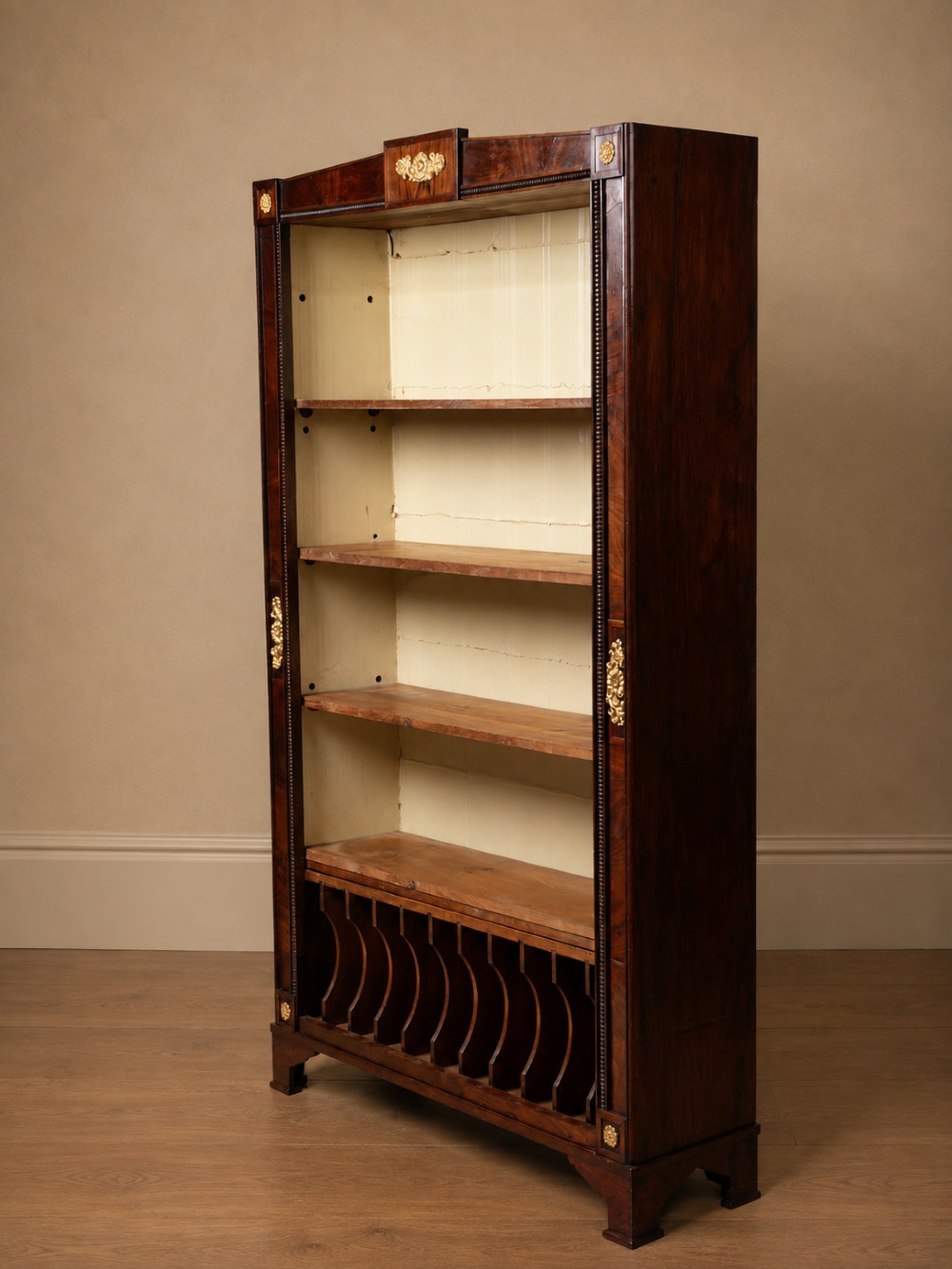 A nineteenth-century French Empire style rosewood open bookcase featuring brass mounts and adjustable shelves above vertical dividers. View XII