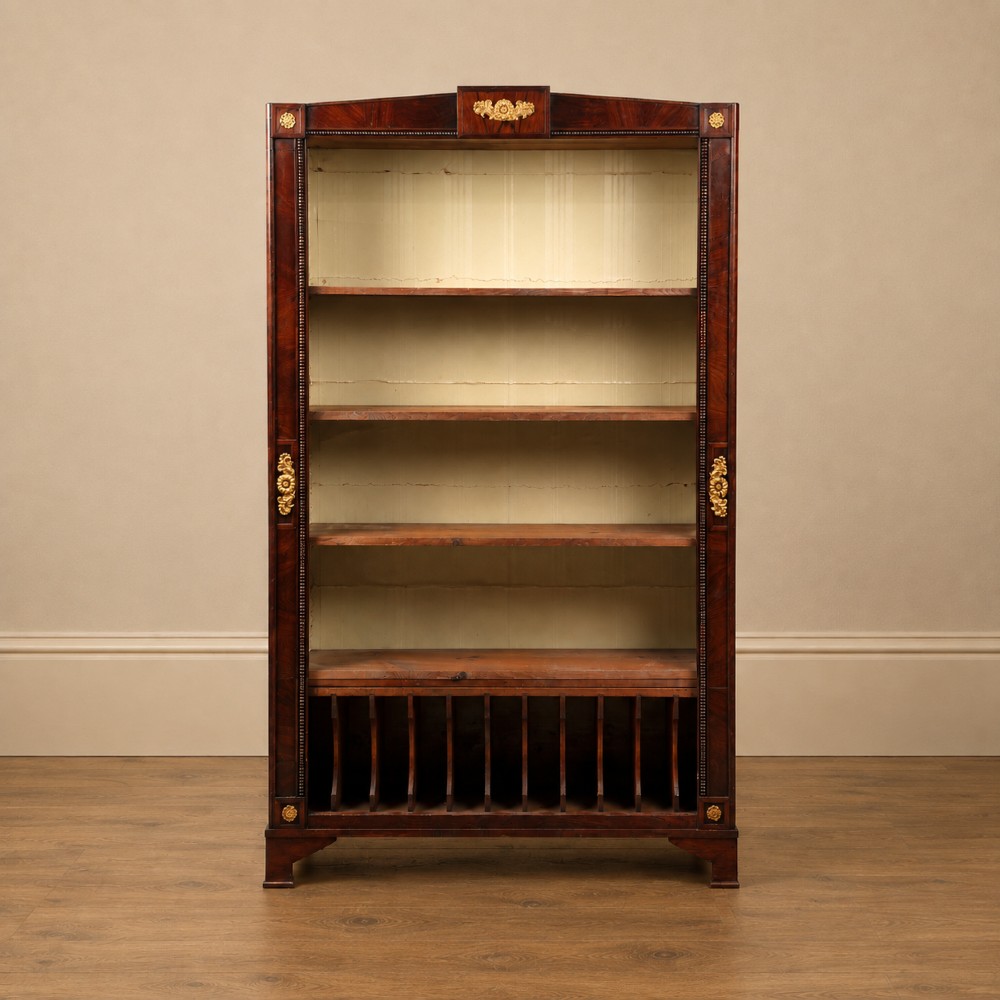 A nineteenth-century French Empire style rosewood open bookcase featuring brass mounts and adjustable shelves above vertical dividers.