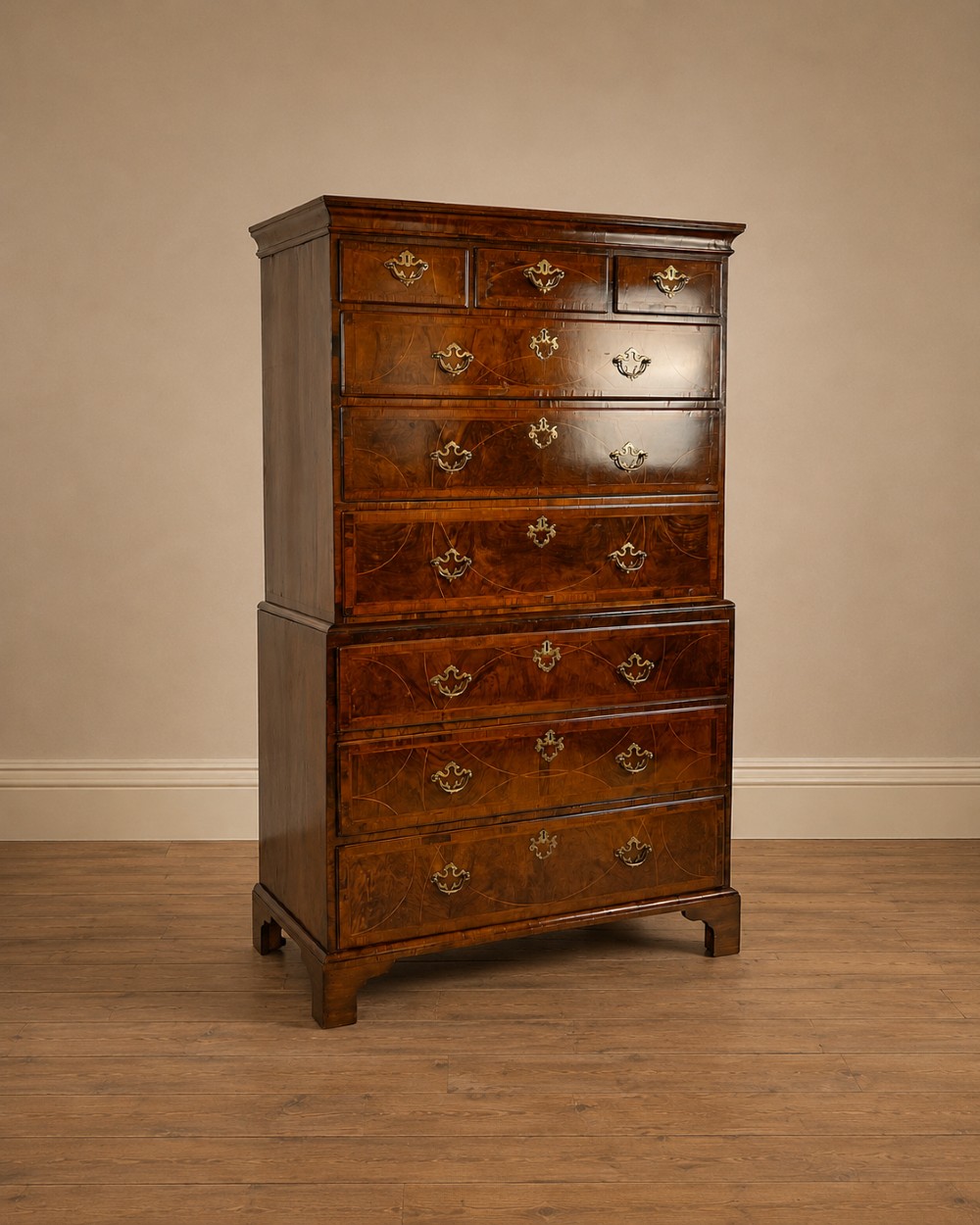 A tall George II two-part walnut chest on chest featuring figured burr walnut drawer fronts with line inlay, brass swan-neck handles, and bracket feet. View XII