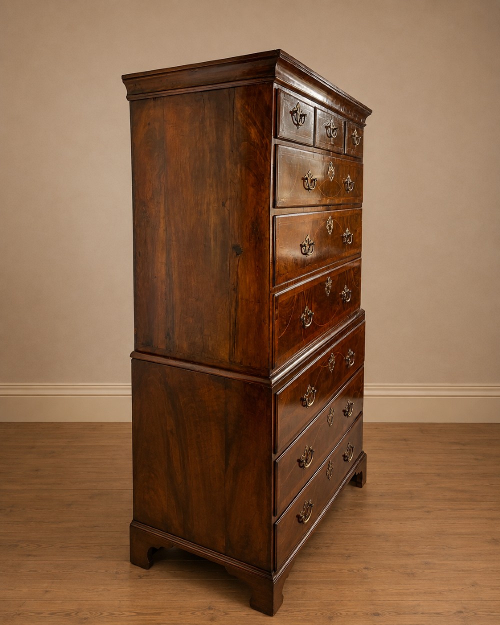 A tall George II two-part walnut chest on chest featuring figured burr walnut drawer fronts with line inlay, brass swan-neck handles, and bracket feet. View XIV