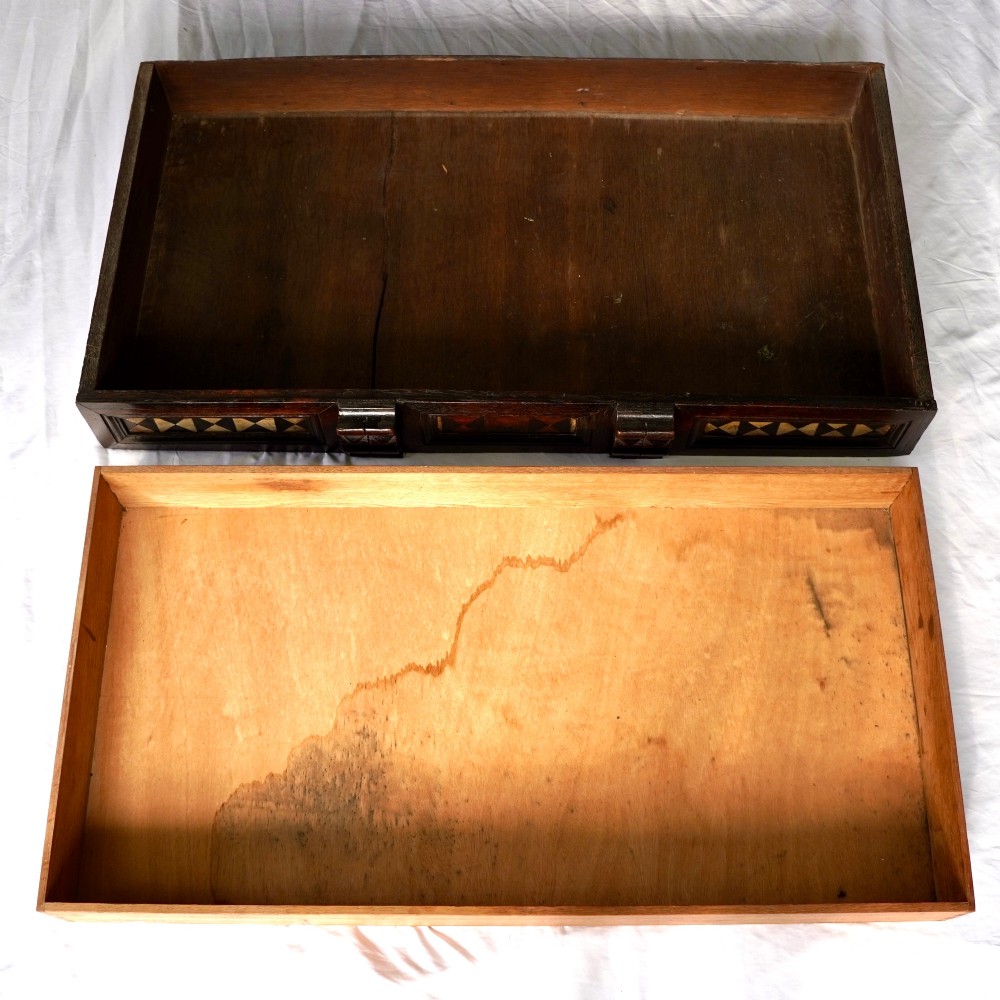 A dark oak 17th-century style chest of drawers featuring geometric timber inlay along the top frieze, applied mouldings, and brass drop handles. View V