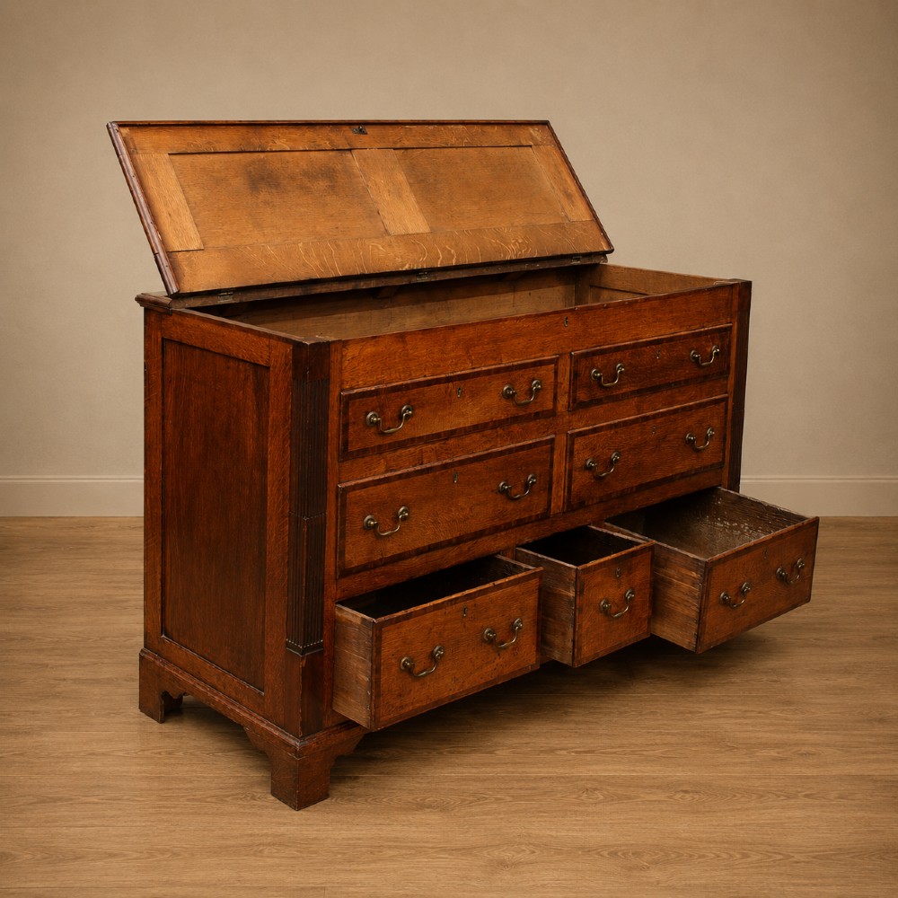 A Georgian oak and mahogany crossbanded Lancashire mule chest with brass handles and bracket feet. View XIII