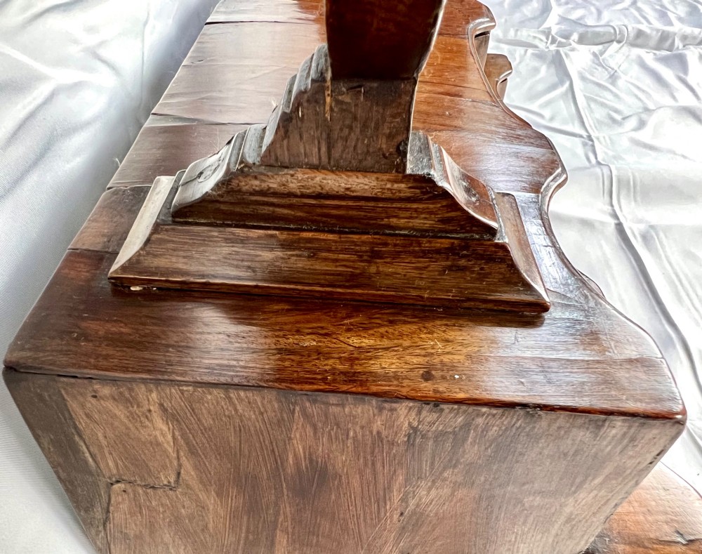 An antique Queen Anne walnut and laburnum toilet mirror featuring an arched cross-banded frame above a serpentine base with miniature drawers. View VIII