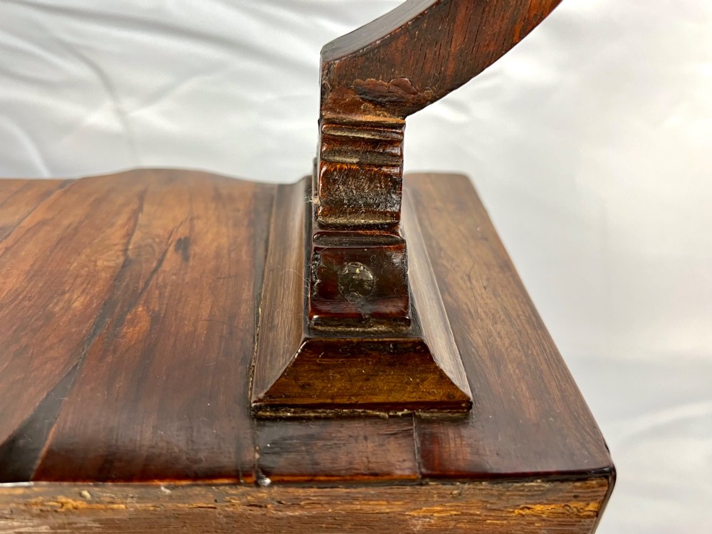 An antique Queen Anne walnut and laburnum toilet mirror featuring an arched cross-banded frame above a serpentine base with miniature drawers. View XII