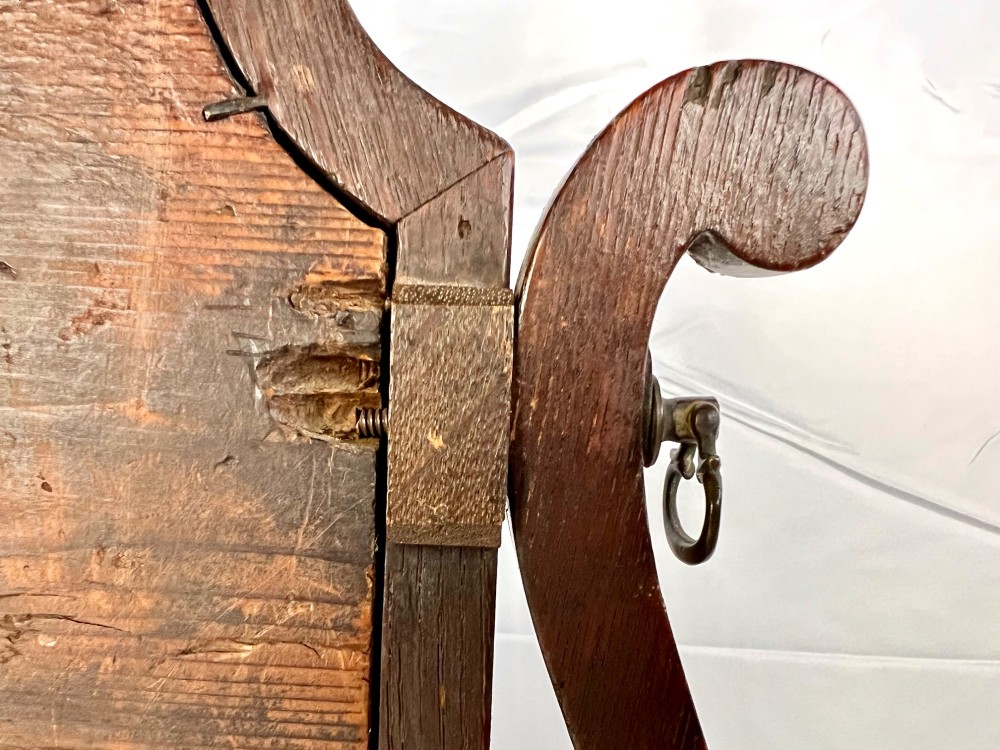 An antique Queen Anne walnut and laburnum toilet mirror featuring an arched cross-banded frame above a serpentine base with miniature drawers. View XIII