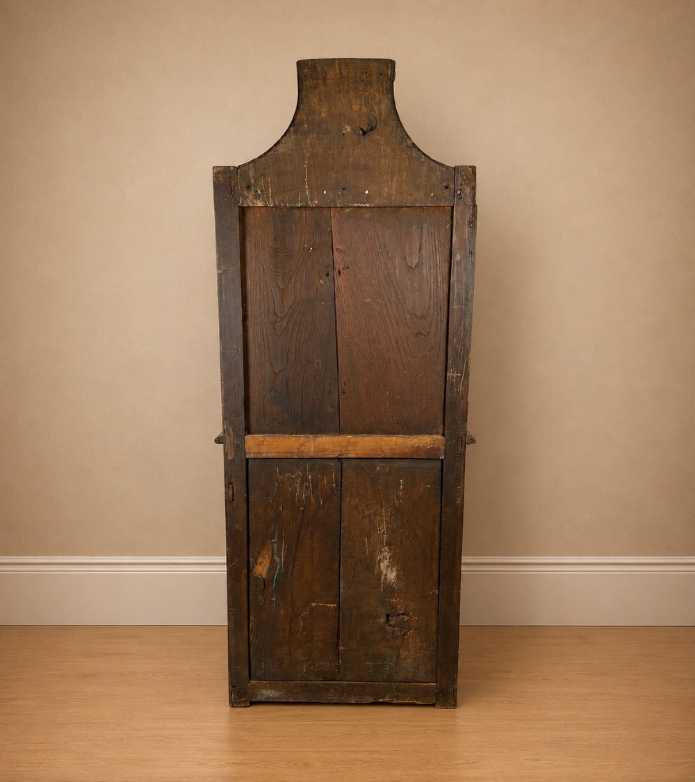 An 18th-century dark chestnut wood lavabo cabinet featuring a carved backboard mounted with a pewter cistern above a matching pewter basin. View XIII