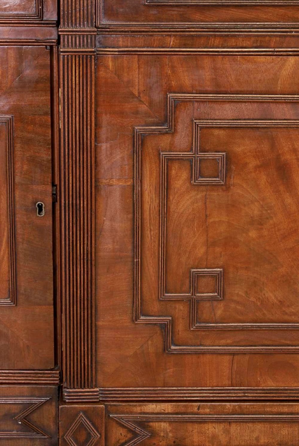 A large George IV mahogany breakfront library bookcase featuring gothic astragal glazed upper doors above drawers and cupboard doors with geometric moulding. View VI