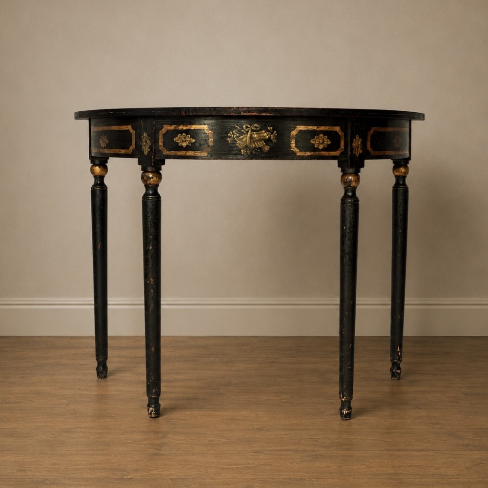 A Regency period semi-circular console table painted black with gold-gilded classical panel motifs and four slender turned legs. View XI