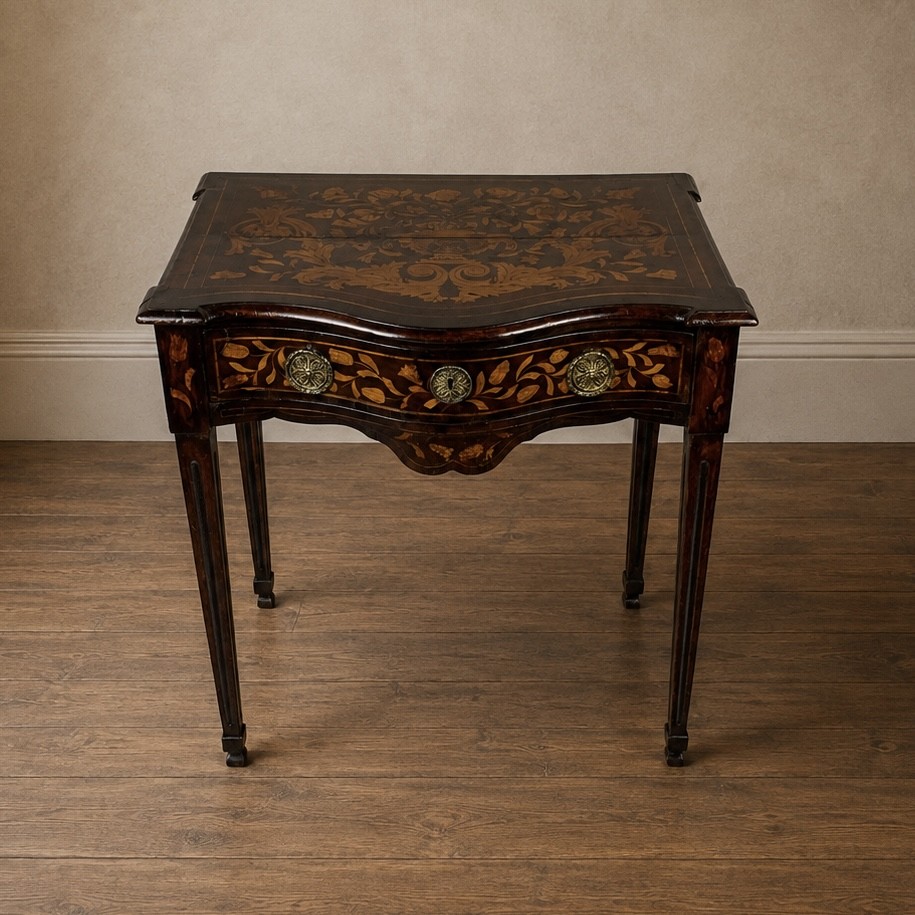 An 18th-century Dutch walnut side table featuring a serpentine front, floral marquetry inlay, a single drawer, and four square tapered legs.