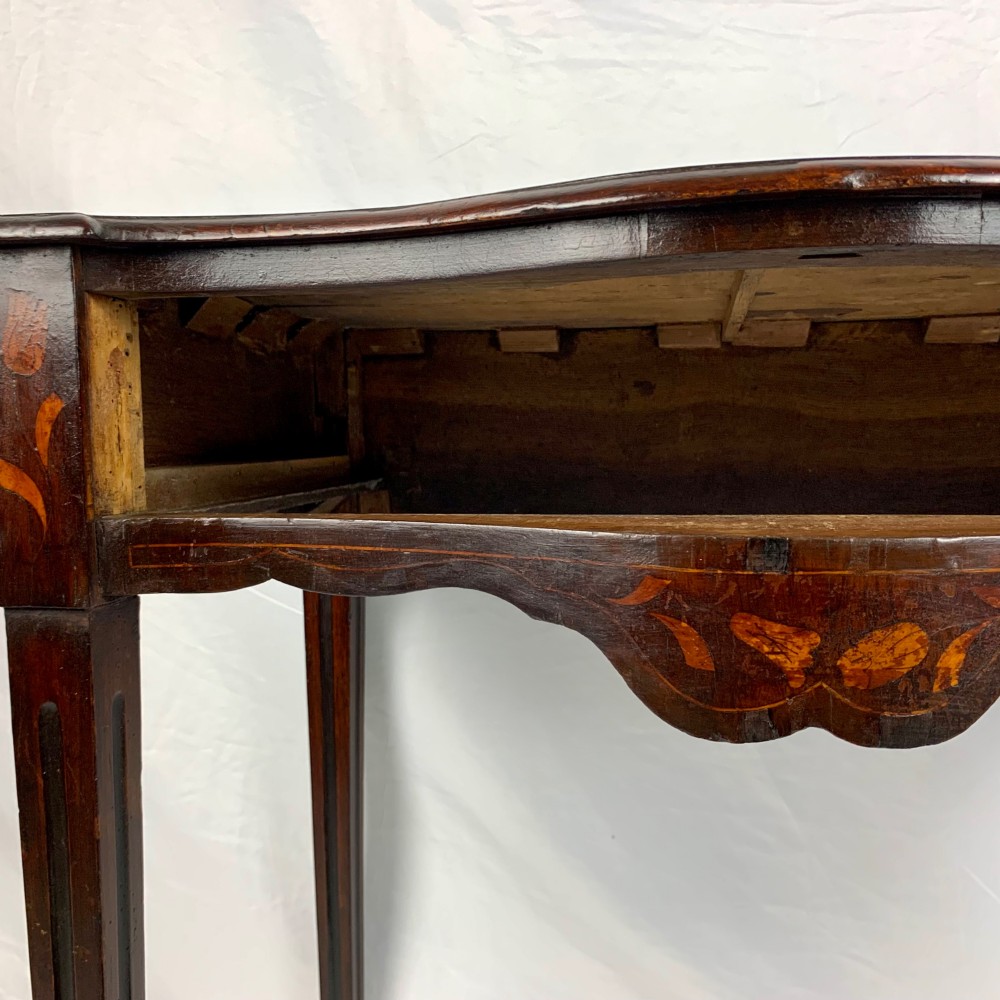 An 18th-century Dutch walnut side table featuring a serpentine front, floral marquetry inlay, a single drawer, and four square tapered legs. View XI