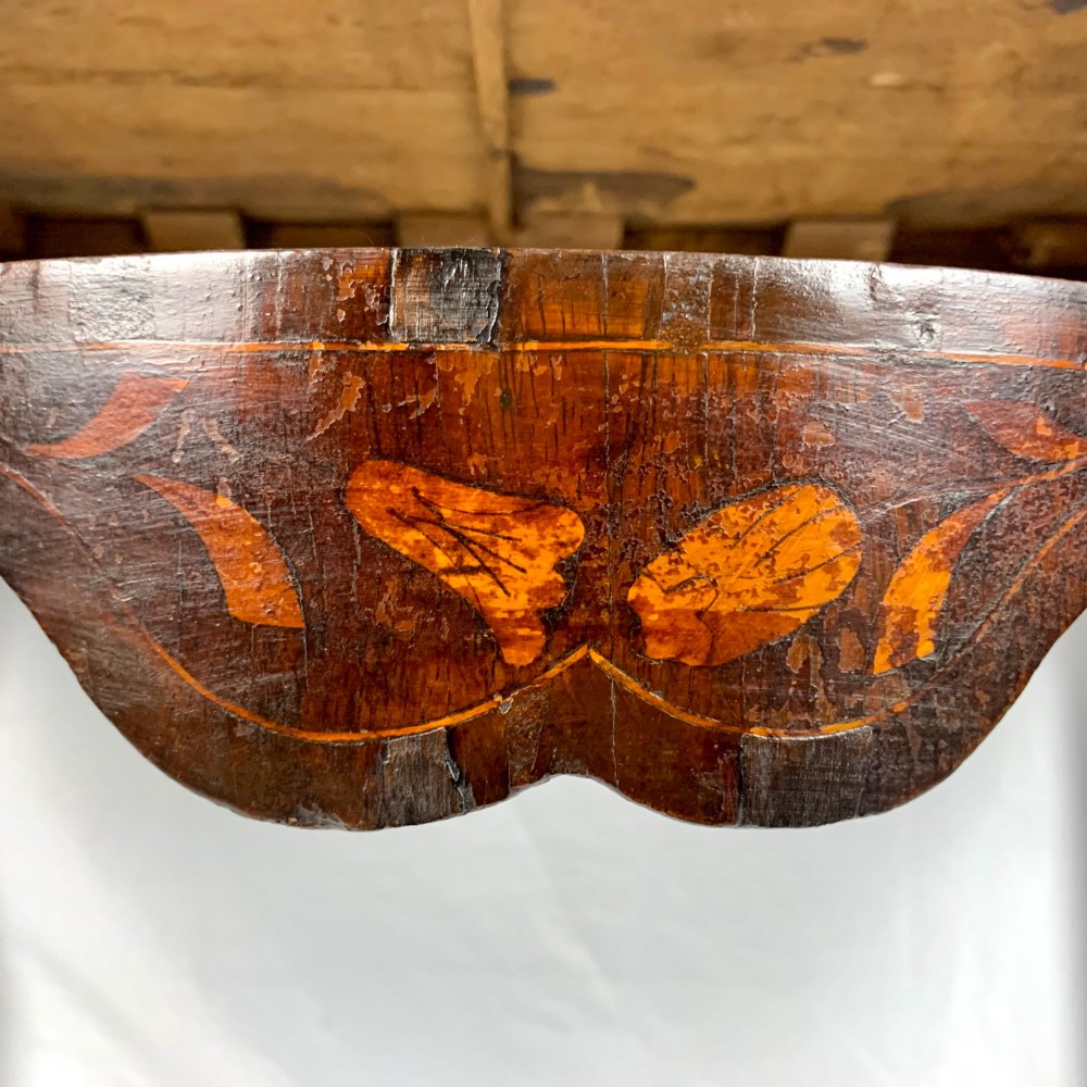 An 18th-century Dutch walnut side table featuring a serpentine front, floral marquetry inlay, a single drawer, and four square tapered legs. View XII