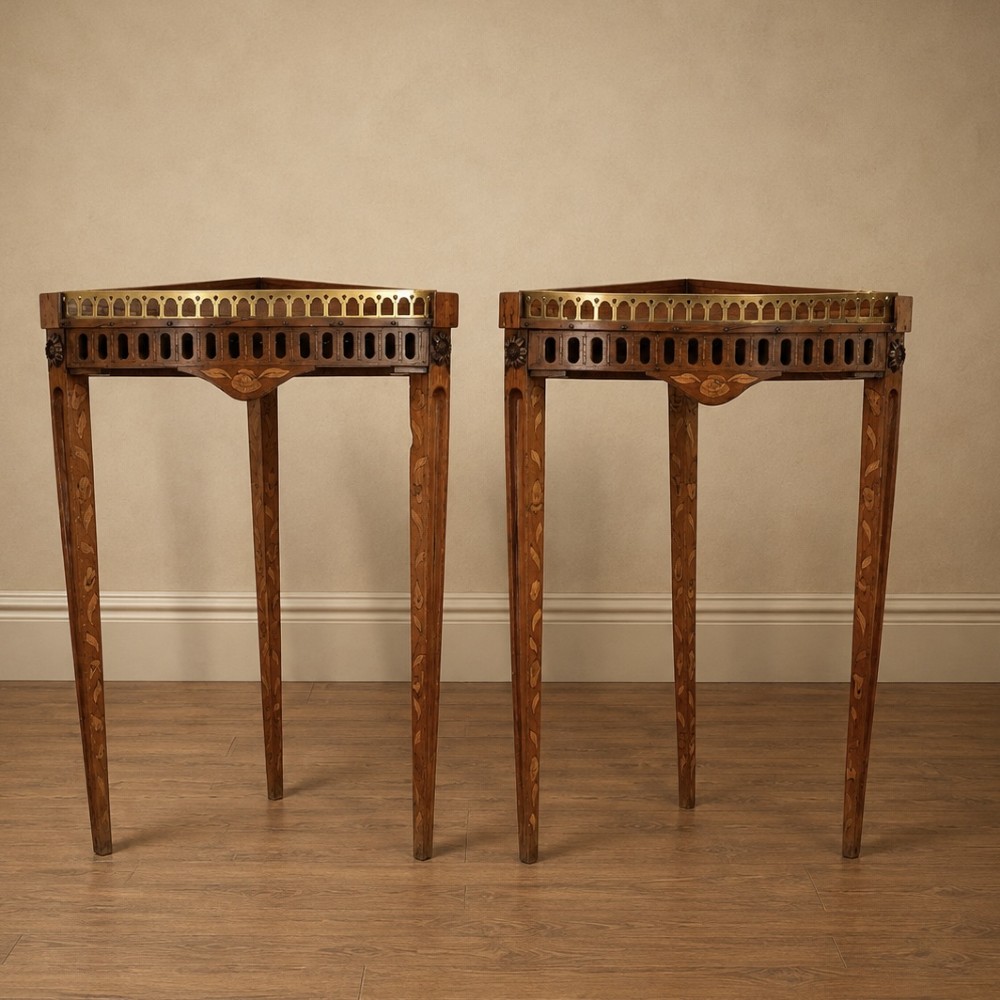 A pair of 18th-century triangular corner tables featuring detailed floral marquetry top surfaces, pierced friezes, tapering legs, and brass galleries. View IX