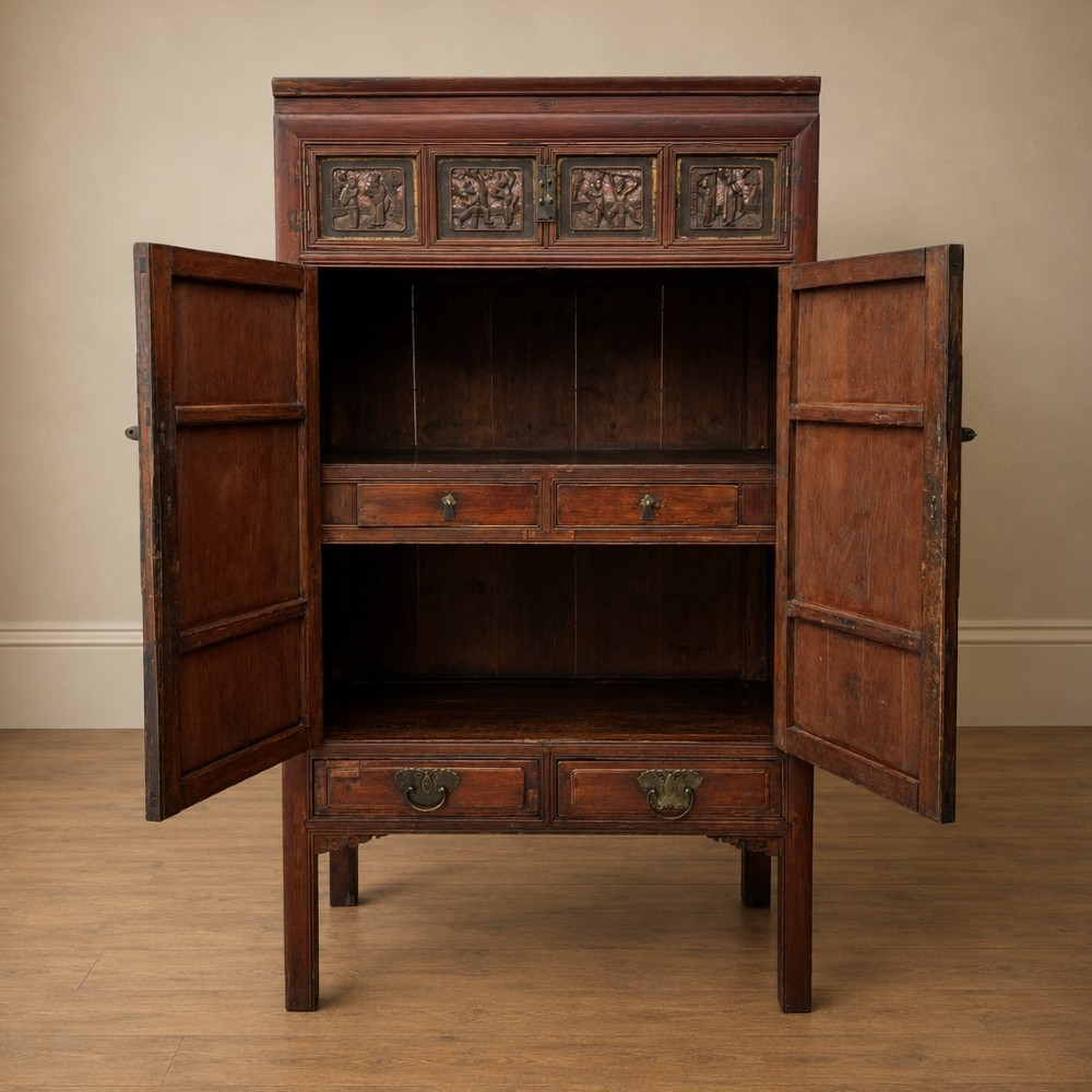 A late 19th-century Chinese red and black lacquer cabinet with double doors decorated with bird and botanical panels above two base drawers. View IV