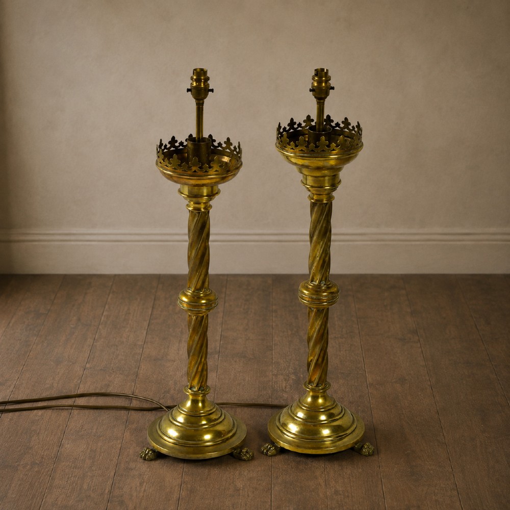 A pair of 19th-century converted brass altar candlesticks with spiral columns, pierced crown drip pans, and cast paw feet. View XII