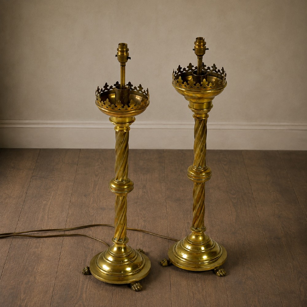 A pair of 19th-century converted brass altar candlesticks with spiral columns, pierced crown drip pans, and cast paw feet. View XIII