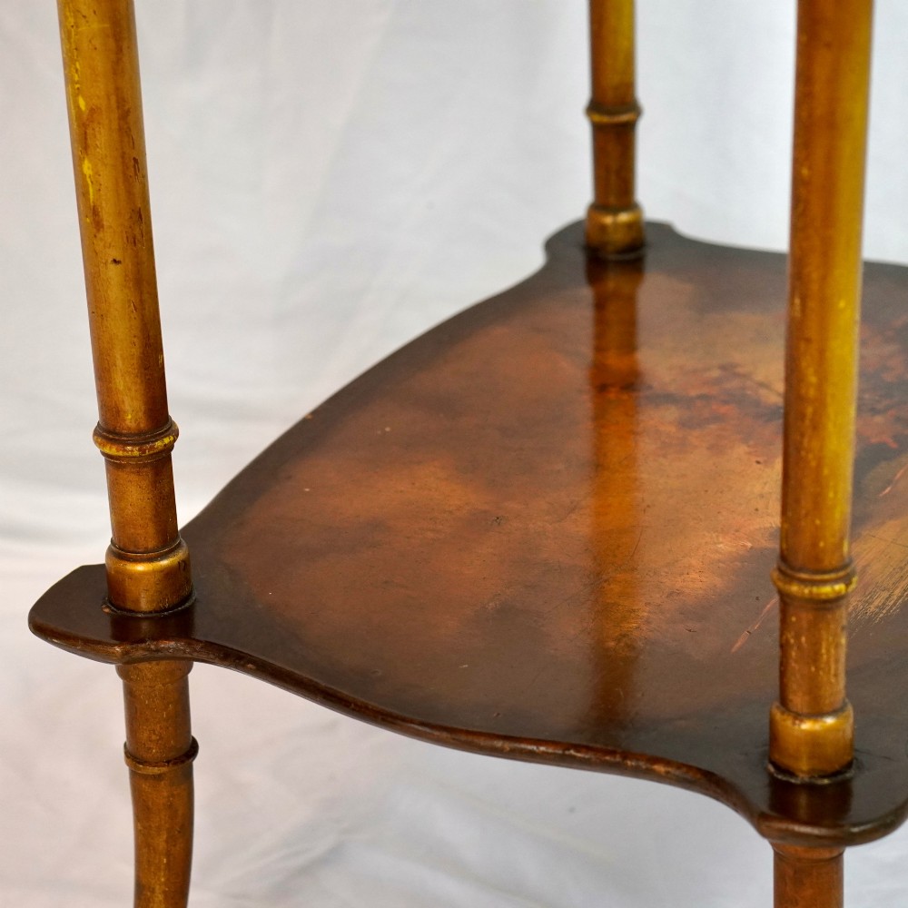 A two-tier continental side table featuring hand-painted figural scenes on shaped wooden surfaces, supported by turned gilt legs. View VIII