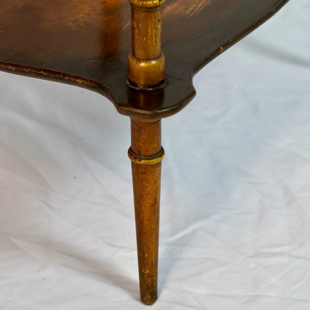A two-tier continental side table featuring hand-painted figural scenes on shaped wooden surfaces, supported by turned gilt legs. View IX