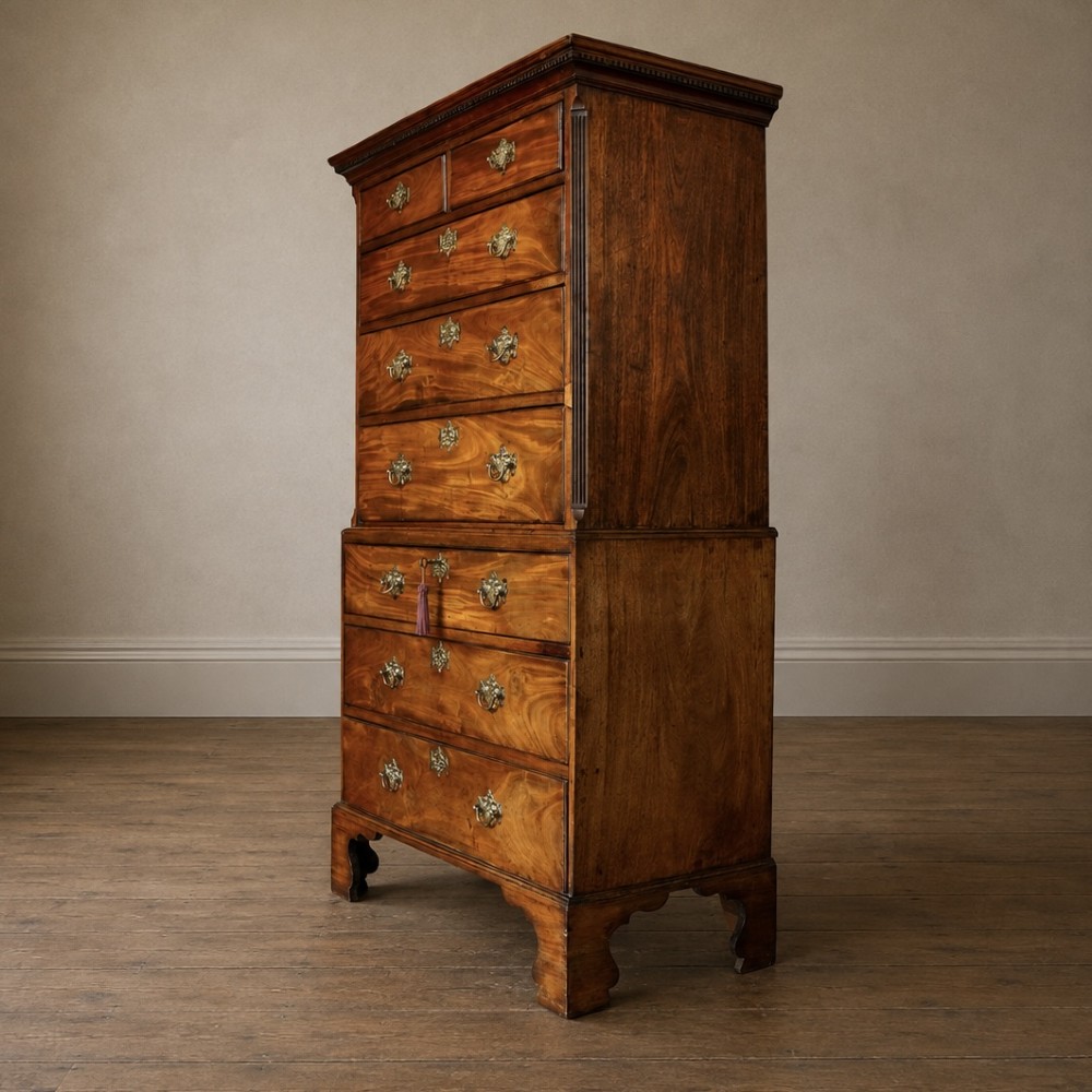 A late 18th-century George III mahogany chest on chest featuring brass swan-neck handles, keyhole escutcheons, dentil moulding, and bracket feet. View XIII