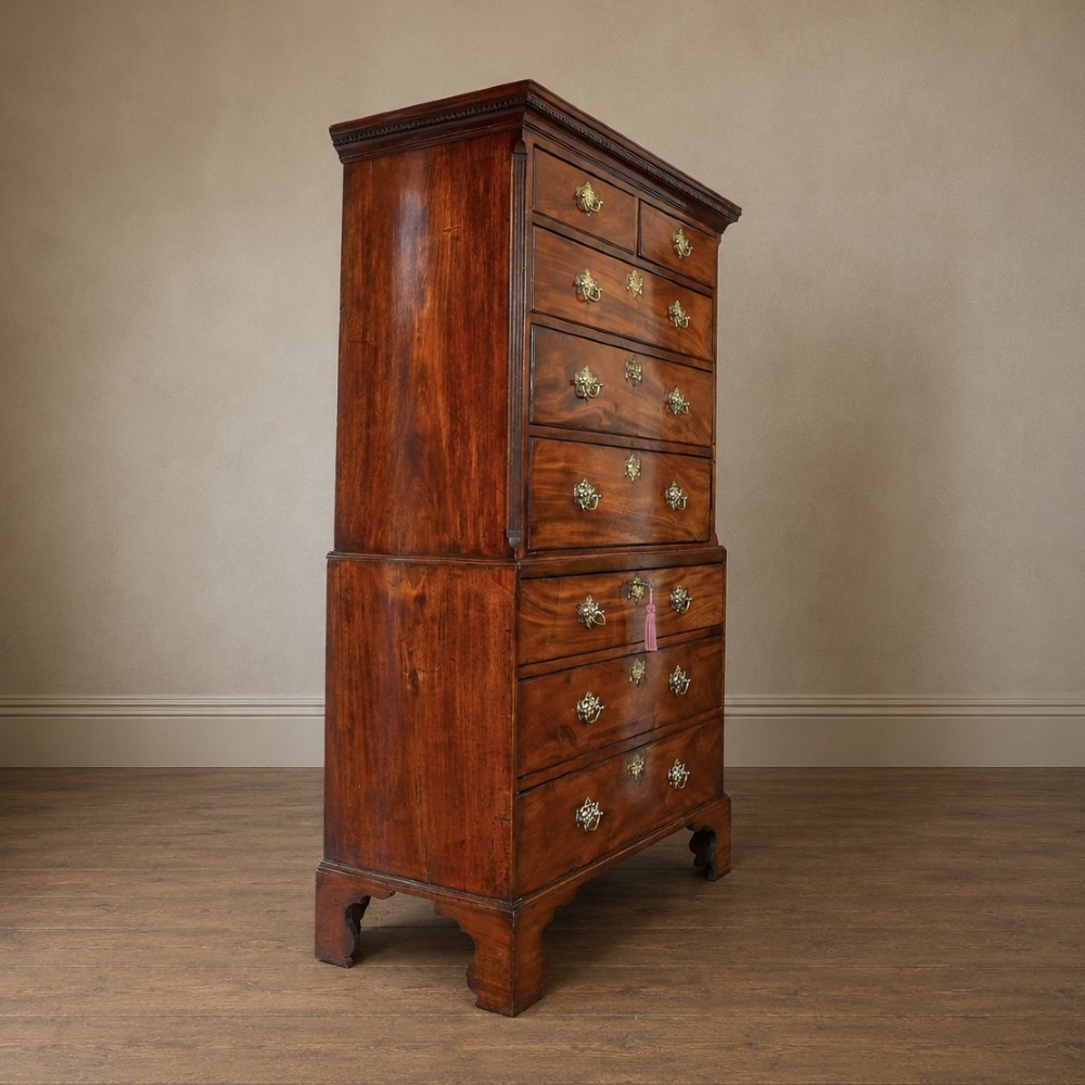 A late 18th-century George III mahogany chest on chest featuring brass swan-neck handles, keyhole escutcheons, dentil moulding, and bracket feet. View XV