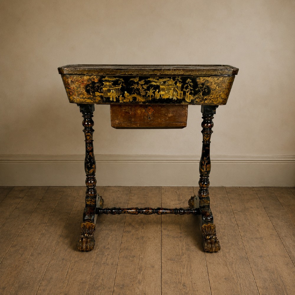 A Regency era black lacquered work table featuring detailed gold chinoiserie motifs, turned legs, a stretcher base, and carved paw feet. View XIII