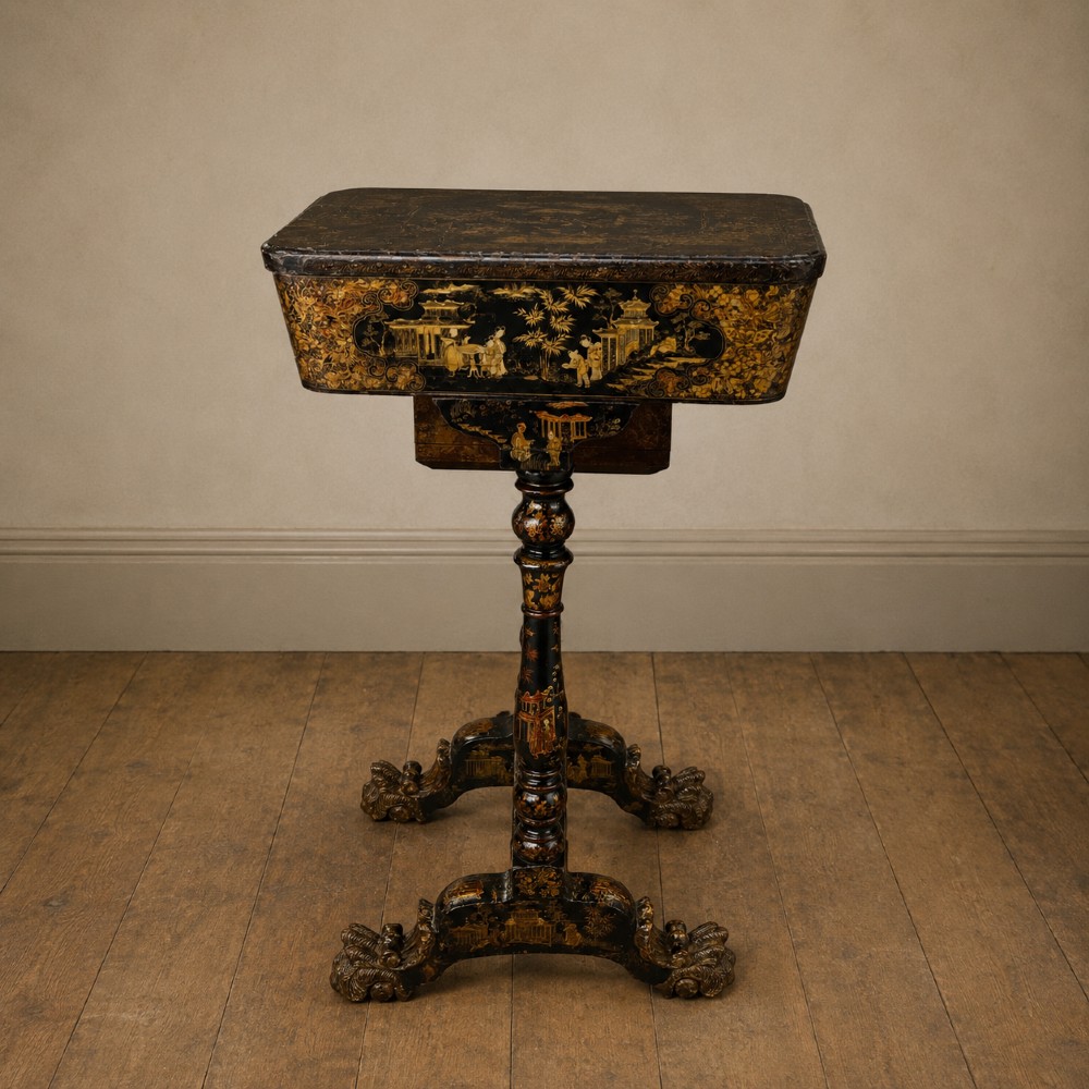 A Regency era black lacquered work table featuring detailed gold chinoiserie motifs, turned legs, a stretcher base, and carved paw feet. View XV