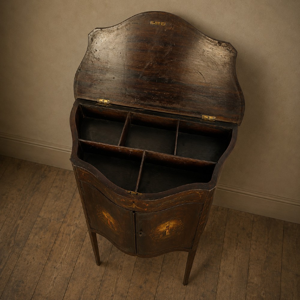 A dark mahogany serpentine-front side cabinet with hand-painted floral swags and figurative door panel vignettes resting on slender square tapered legs. View VII