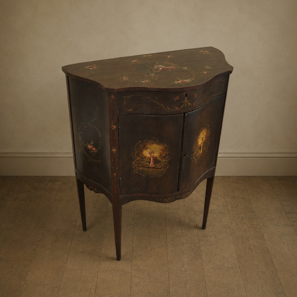 A dark mahogany serpentine-front side cabinet with hand-painted floral swags and figurative door panel vignettes resting on slender square tapered legs. View XI