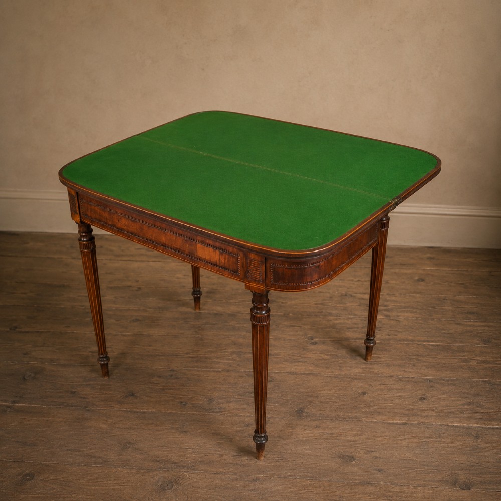 An antique Regency rosewood fold-over card table featuring burr yew crossbanding, a rectangular top with rounded corners, and slender fluted tapered legs. View VIII