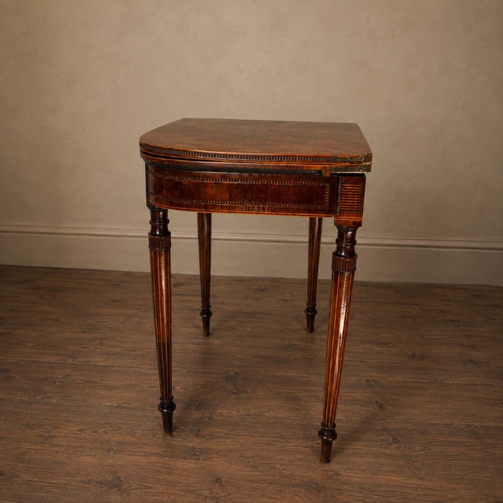 An antique Regency rosewood fold-over card table featuring burr yew crossbanding, a rectangular top with rounded corners, and slender fluted tapered legs. View XII