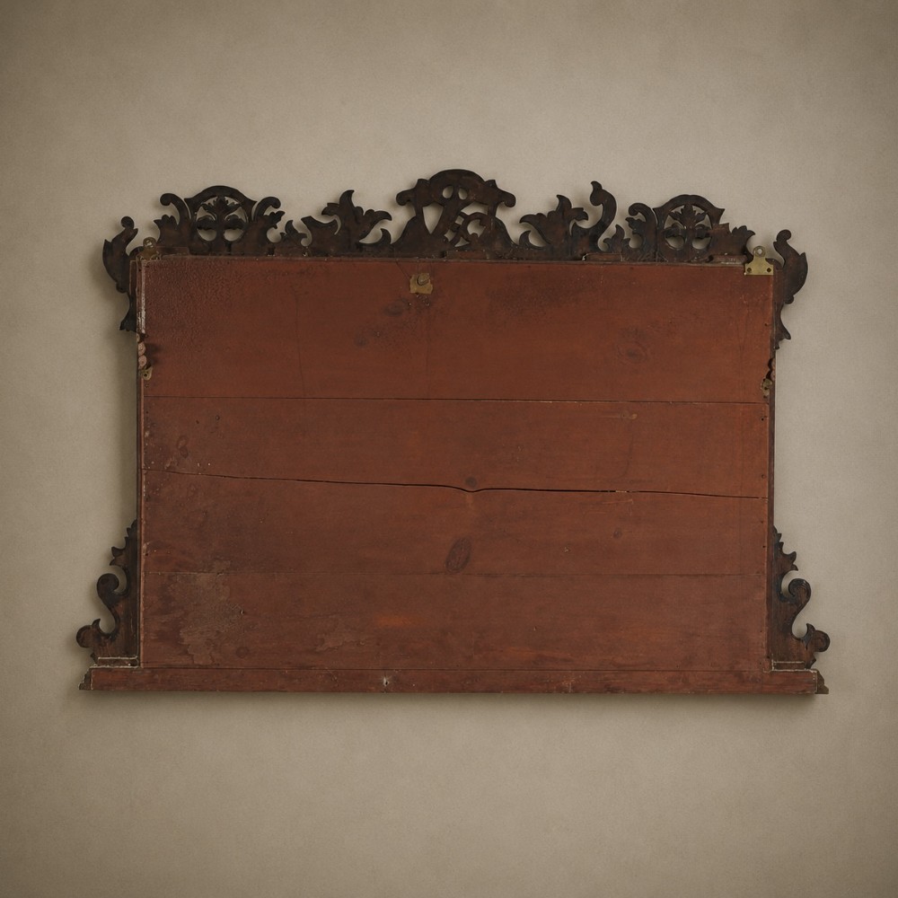 A dark mahogany triptych overmantel mirror with carved pierced fretwork, three mirror panels, and a gilded ho-ho bird cresting. View XII