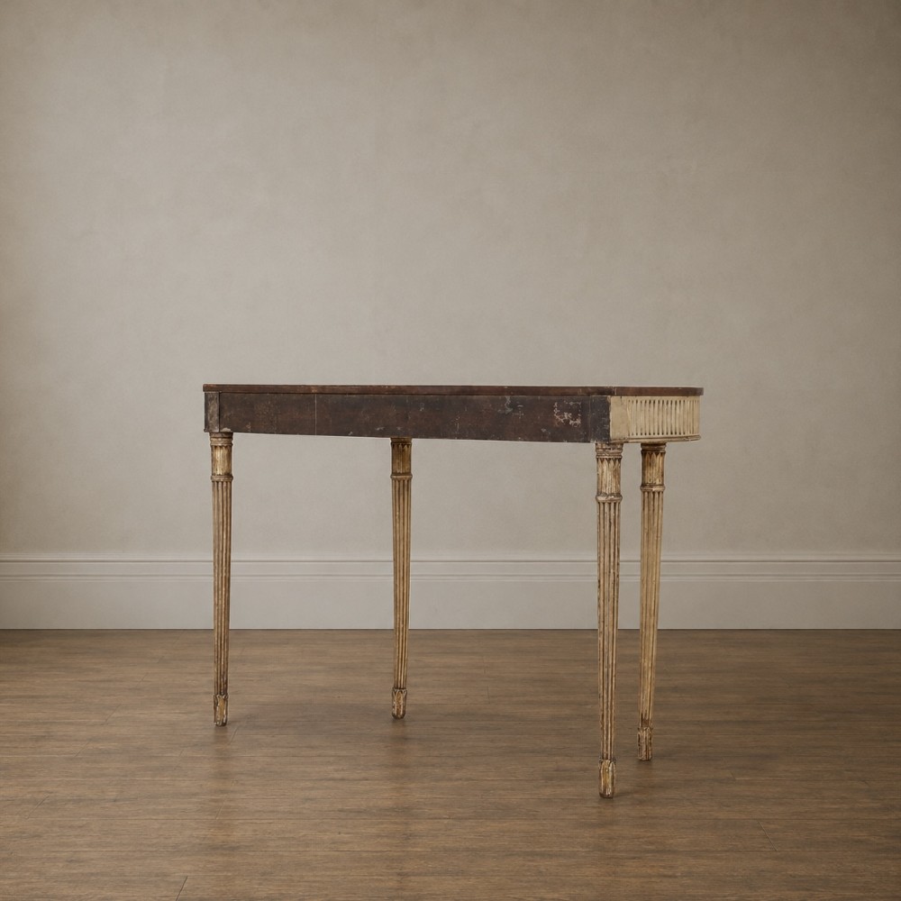 A Georgian style painted cream and gilt console table featuring a dark wood top, fluted legs, and carved swag detailing. View III
