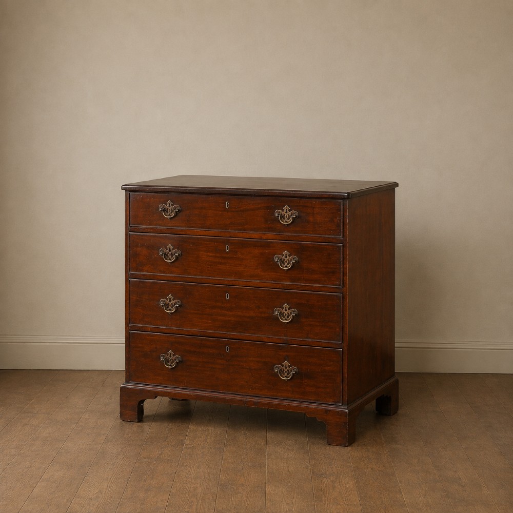 A George II dark mahogany straight-front chest featuring four graduated long drawers with decorative brass swan-neck handles and bracket feet. View V