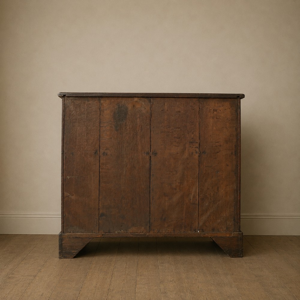 A George II dark mahogany straight-front chest featuring four graduated long drawers with decorative brass swan-neck handles and bracket feet. View VI