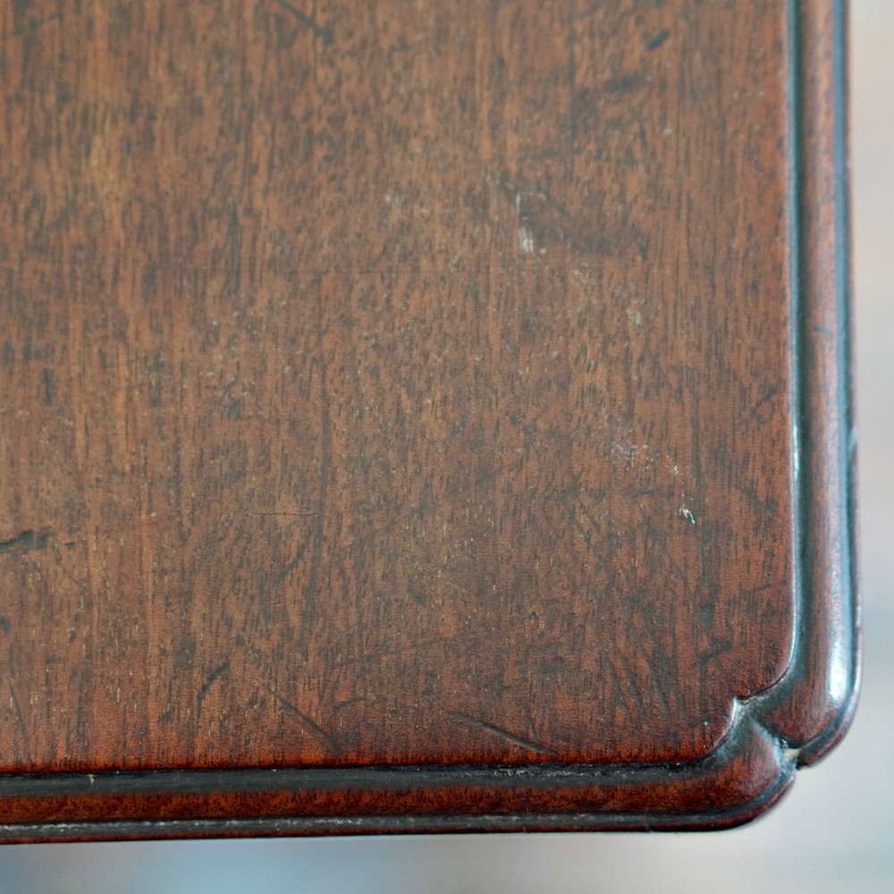 A George II dark mahogany straight-front chest featuring four graduated long drawers with decorative brass swan-neck handles and bracket feet. View VII