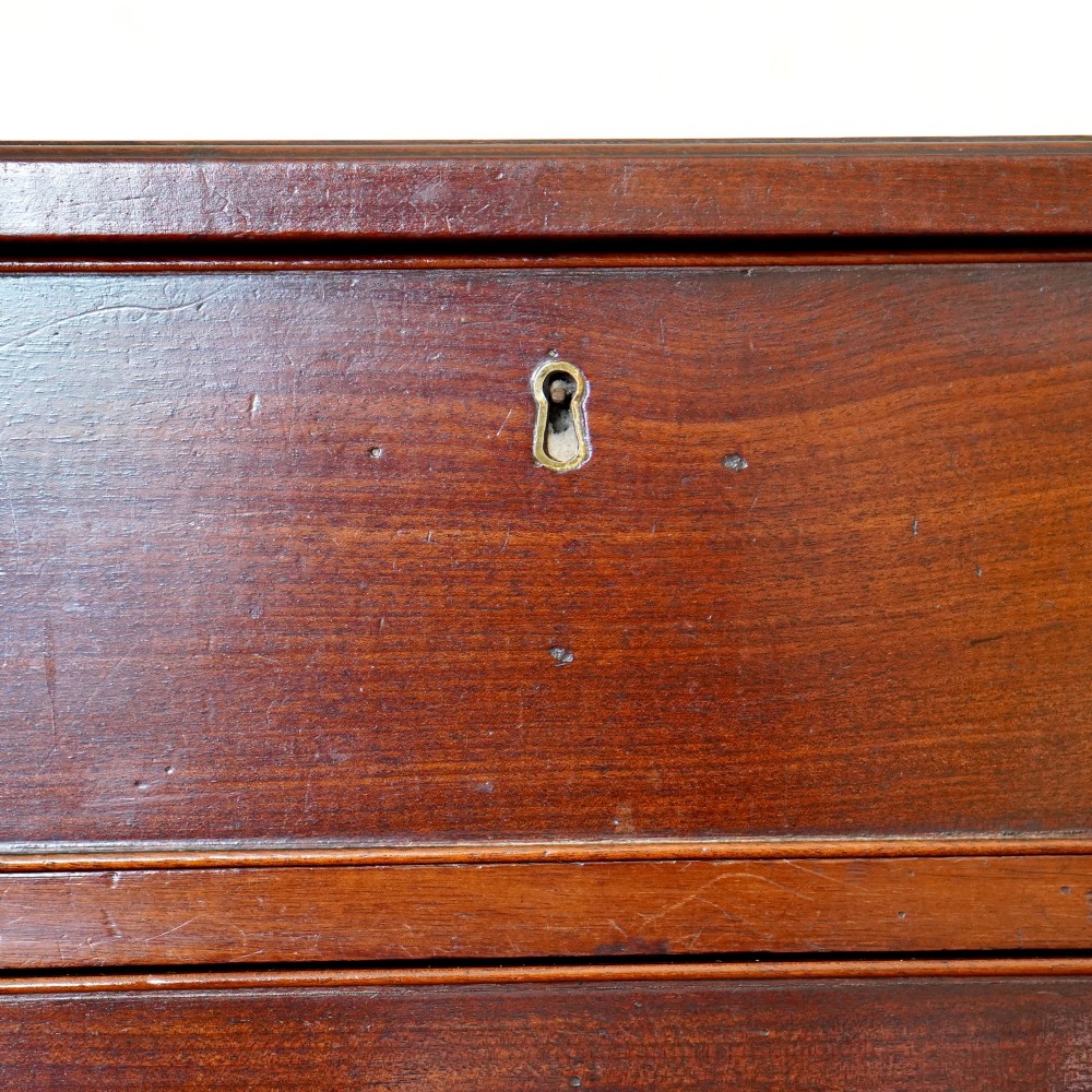 A George II dark mahogany straight-front chest featuring four graduated long drawers with decorative brass swan-neck handles and bracket feet. View VIII