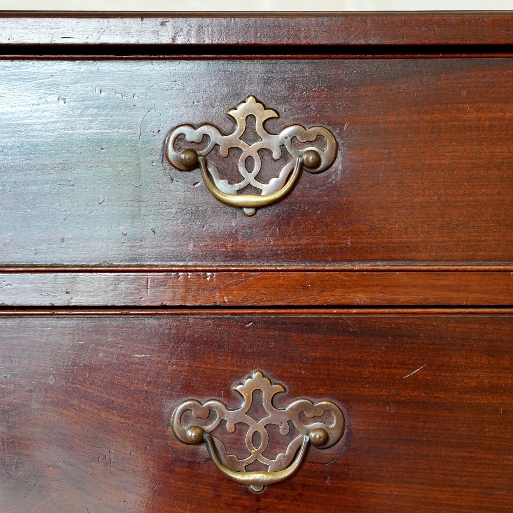 A George II dark mahogany straight-front chest featuring four graduated long drawers with decorative brass swan-neck handles and bracket feet. View IX