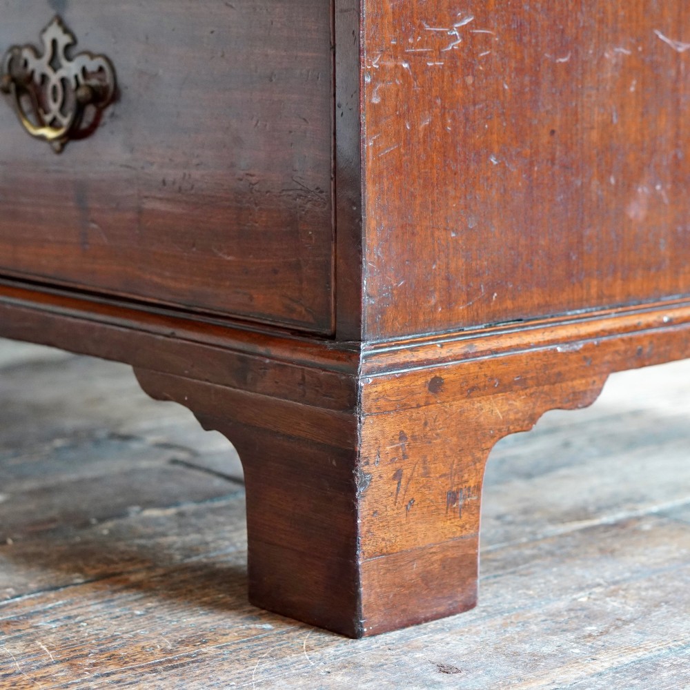 A George II dark mahogany straight-front chest featuring four graduated long drawers with decorative brass swan-neck handles and bracket feet. View XIV