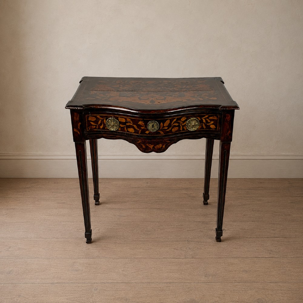 An 18th-century Dutch walnut side table featuring a serpentine front, floral marquetry inlay, a single drawer, and four square tapered legs.