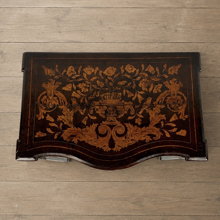 An 18th-century Dutch walnut side table featuring a serpentine front, floral marquetry inlay, a single drawer, and four square tapered legs. View II