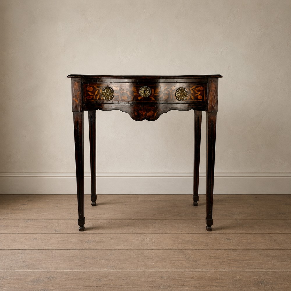 An 18th-century Dutch walnut side table featuring a serpentine front, floral marquetry inlay, a single drawer, and four square tapered legs. View III