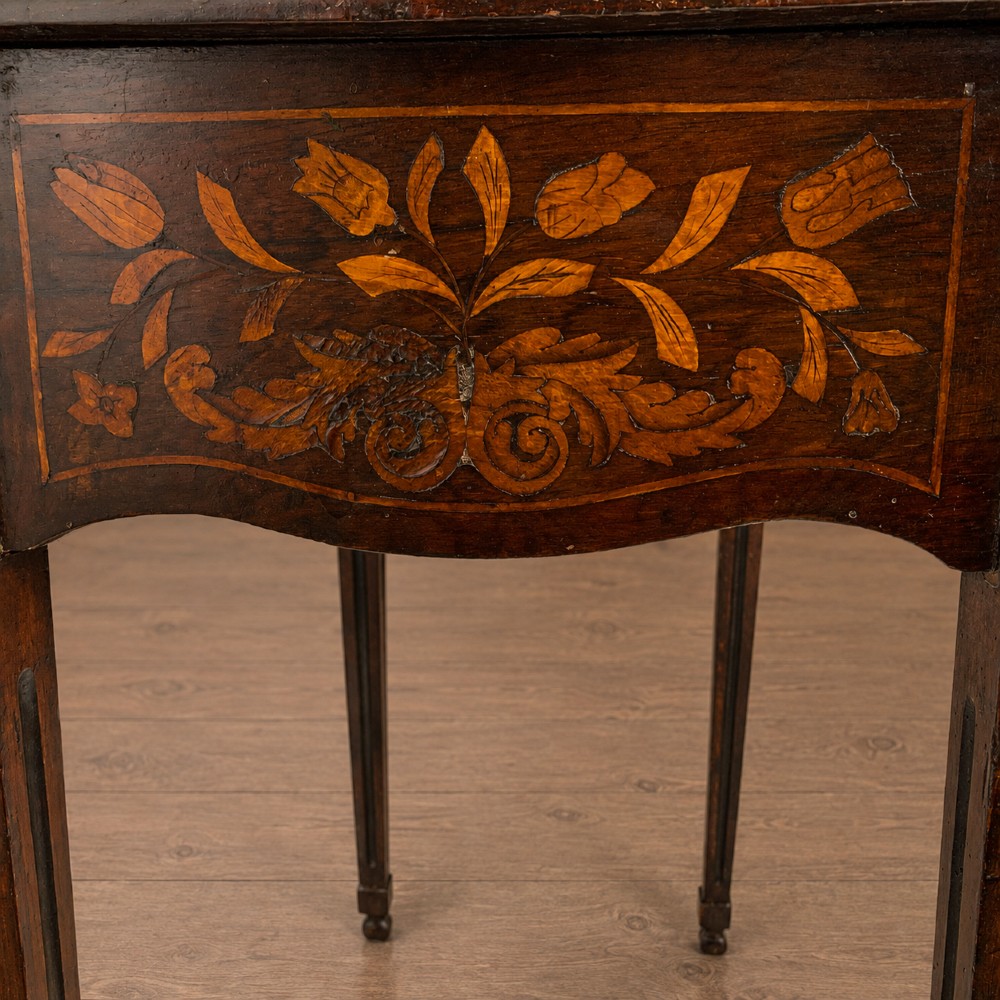 An 18th-century Dutch walnut side table featuring a serpentine front, floral marquetry inlay, a single drawer, and four square tapered legs. View IX