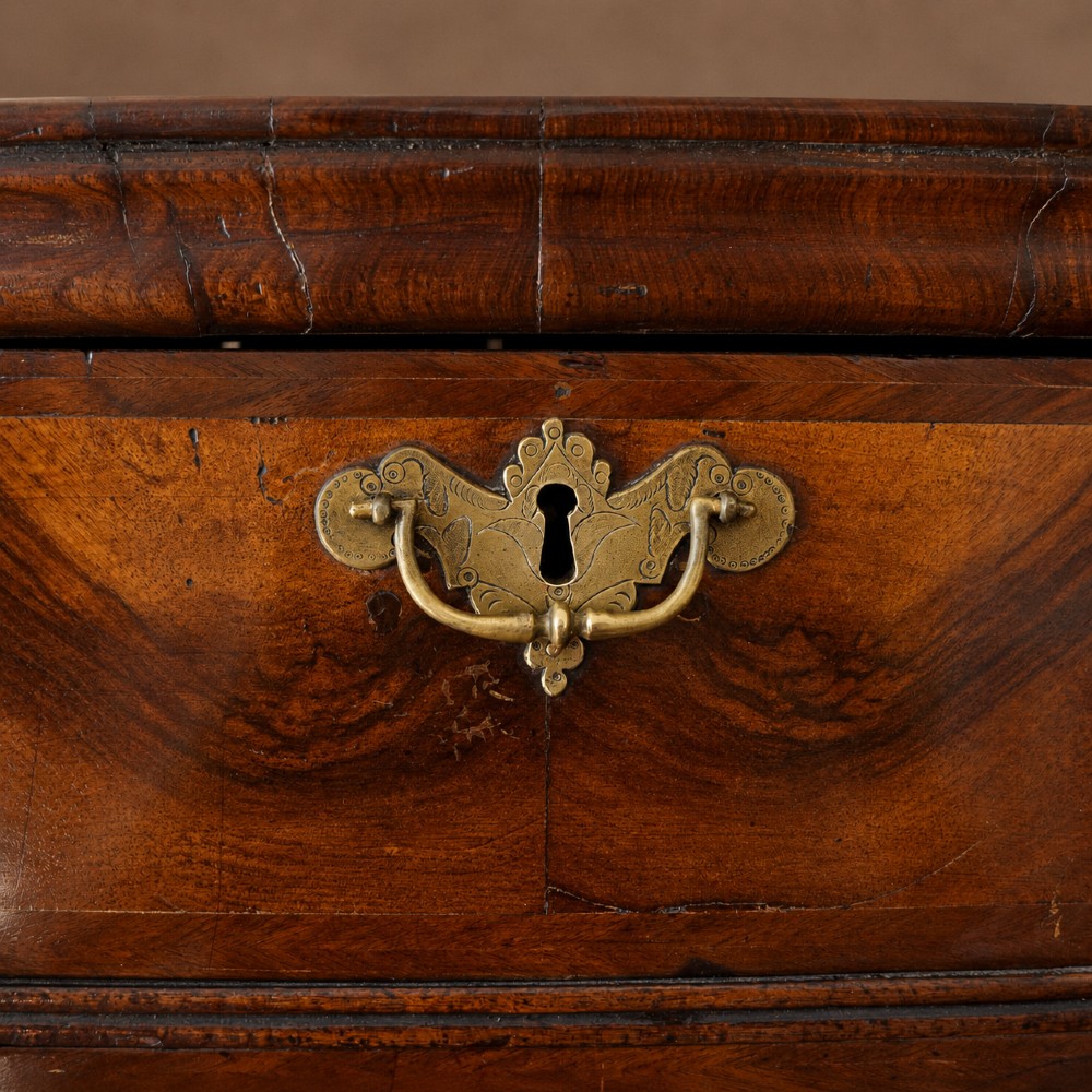 A George I period figured walnut chest on stand featuring engraved brass escutcheons and six barley-twist legs. View VIII