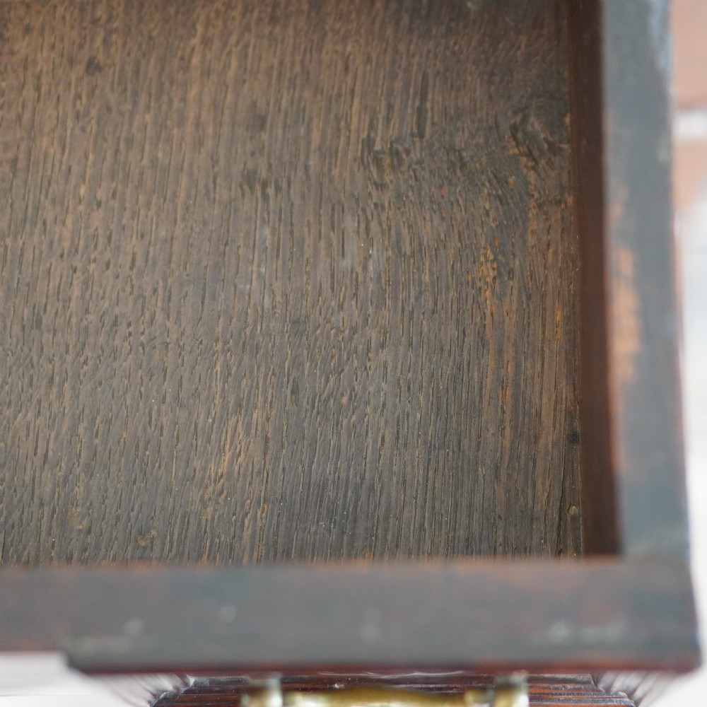 An early eighteenth-century oak chest of drawers featuring four drawers decorated with geometric applied mouldings and brass drop handles. View XIV