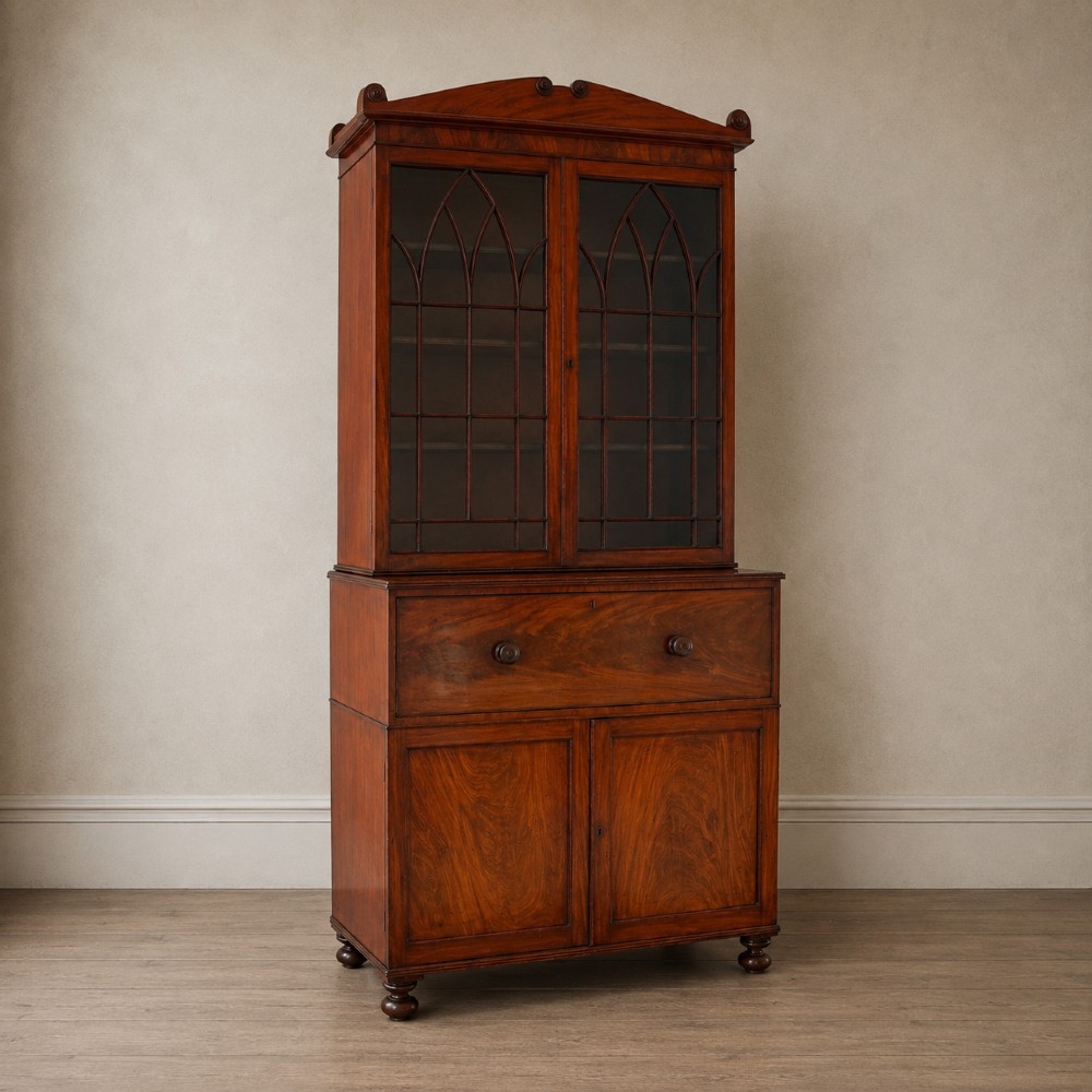 A nineteenth-century George IV mahogany secretaire bookcase with glazed upper doors featuring gothic tracery and a drop-down desk drawer revealing a fitted interior. View V