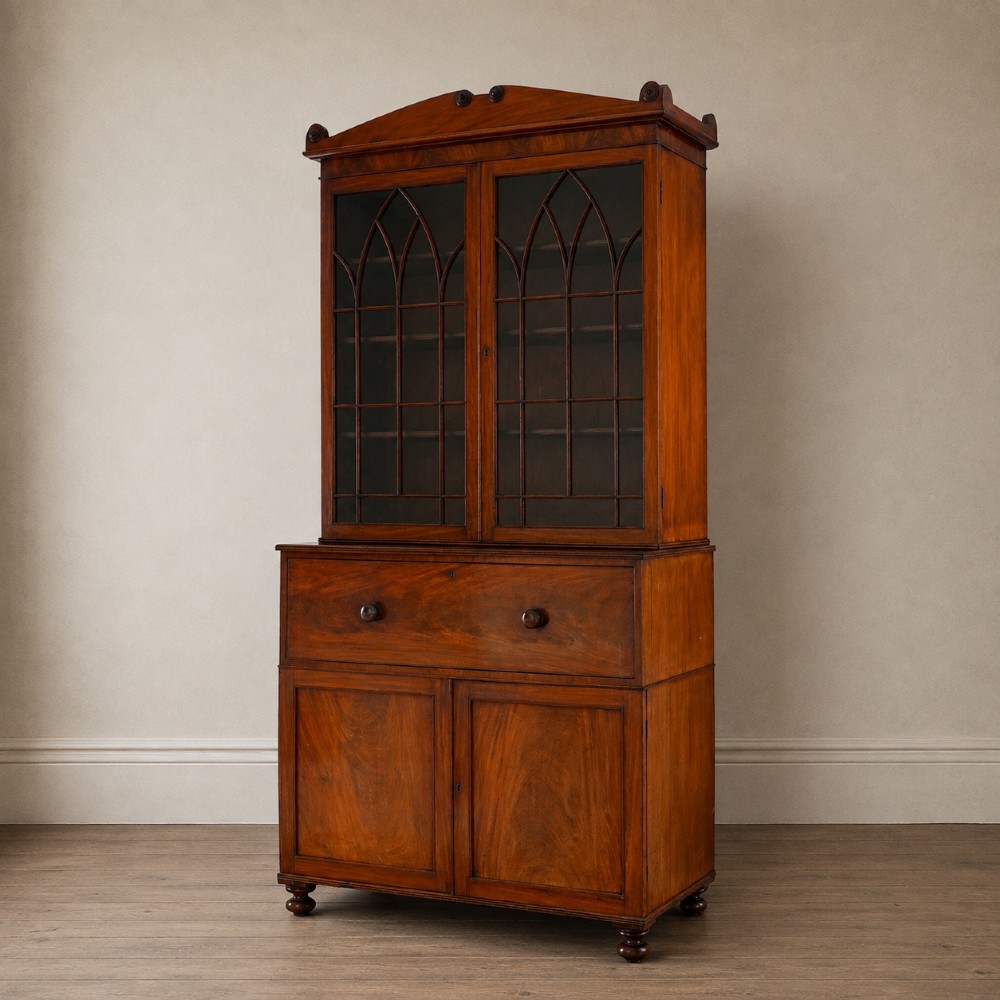 A nineteenth-century George IV mahogany secretaire bookcase with glazed upper doors featuring gothic tracery and a drop-down desk drawer revealing a fitted interior. View VI
