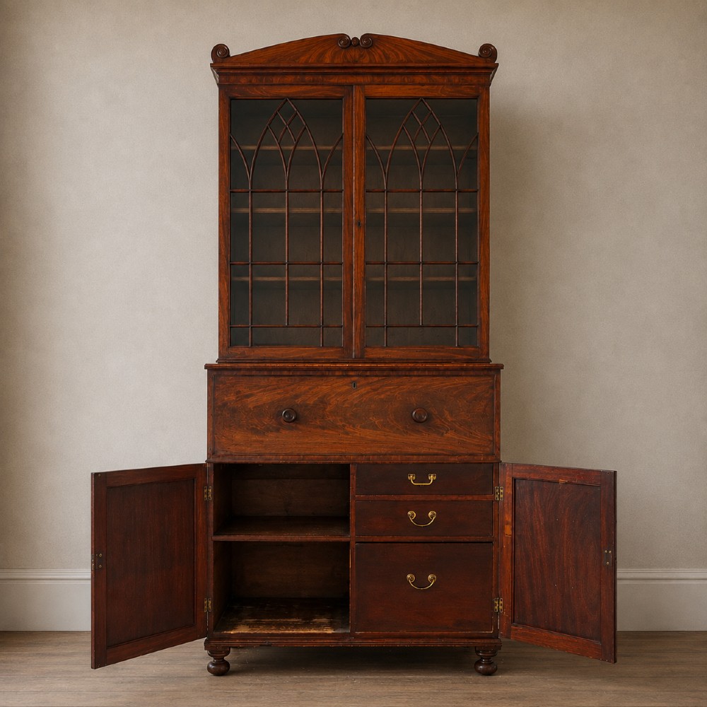 A nineteenth-century George IV mahogany secretaire bookcase with glazed upper doors featuring gothic tracery and a drop-down desk drawer revealing a fitted interior. View VII