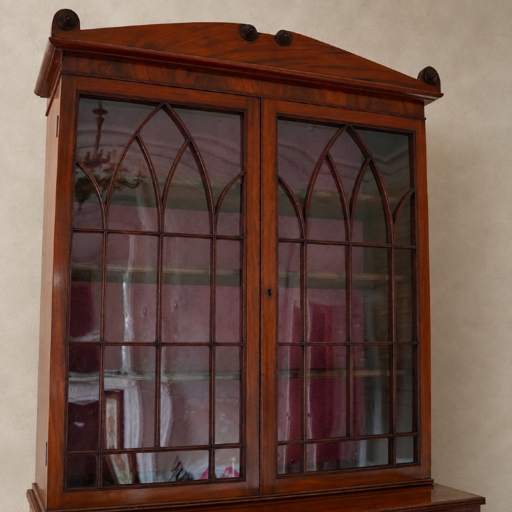 A nineteenth-century George IV mahogany secretaire bookcase with glazed upper doors featuring gothic tracery and a drop-down desk drawer revealing a fitted interior. View VIII